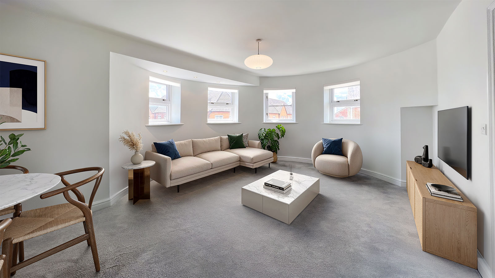 Photo of an empty living room space with curved walls and windows, ready for virtual staging